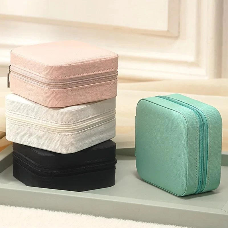 Portable Mini Jewelry Storage Box with compact and elegant design, in pastel colors, featuring high-quality materials and multi-compartment interior.