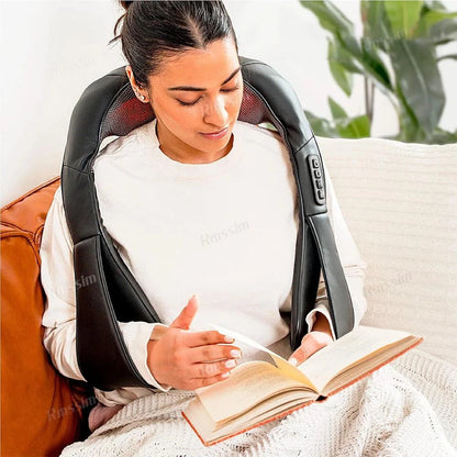 Woman using Shiatsu Neck and Back Massager with adjustable intensity and heat therapy, relaxing on a couch while reading.