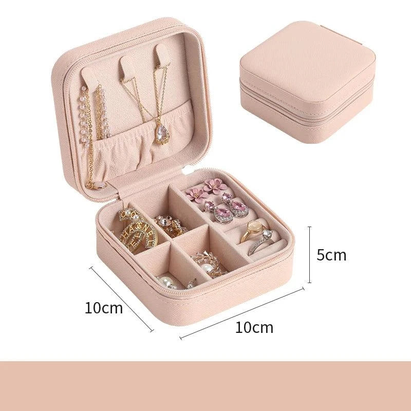 Portable mini jewelry storage box with multiple compartments, beige color, ideal for travel and home use.