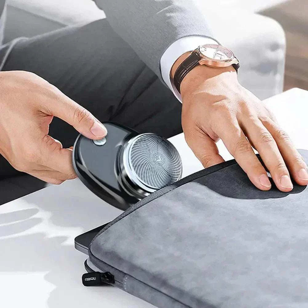 Man placing Mini Portable Electric Shaver into a bag, showcasing its compact and portable design.