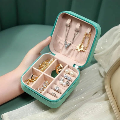 Portable Mini Jewelry Storage Box with multi-compartment design, ideal for travel and home use, featuring a velvet-lined interior for scratch-free protection.