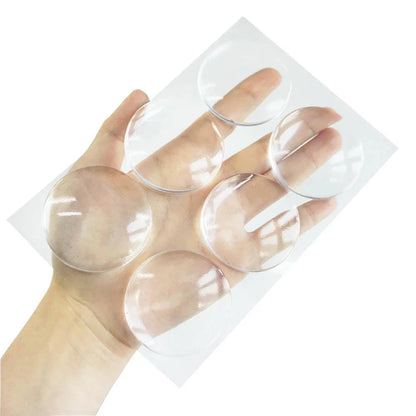 Round transparent soft silicone non-slip door stopper set on hand.