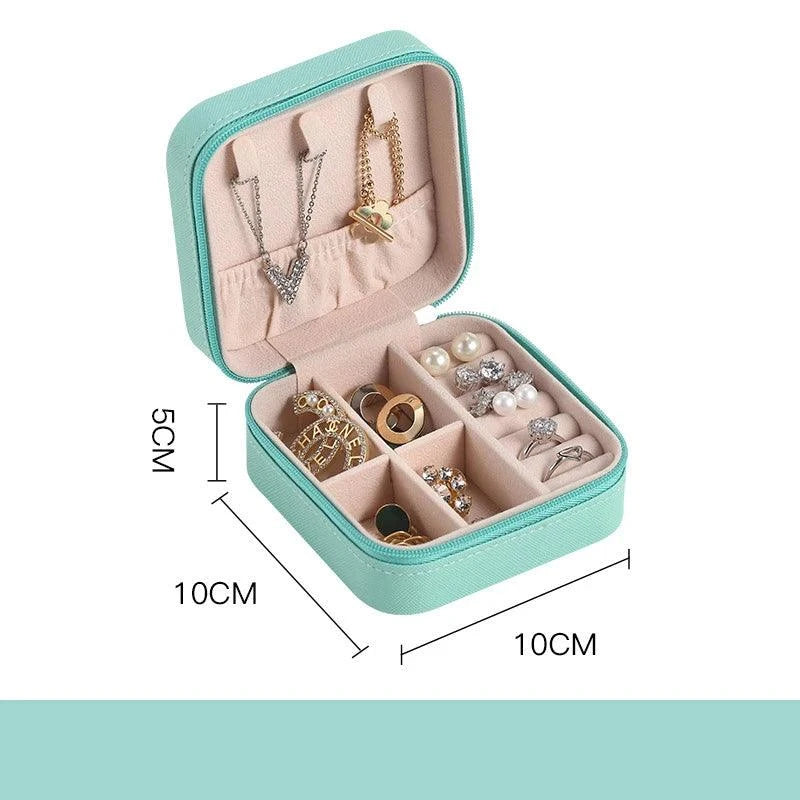 Portable mini jewelry storage box with compartments, mint green, travel-friendly size, 10x10x5cm, velvet-lined interior for necklaces, rings, earrings.