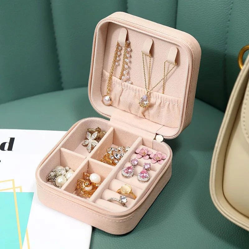 Portable Mini Jewelry Storage Box with velvet-lined interior and multiple compartments for rings, earrings, necklaces, and bracelets. Perfect for travel, keeping jewelry organized and scratch-free.